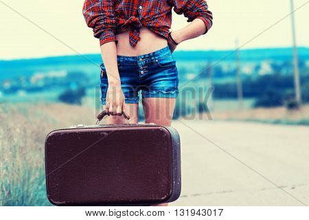 Girl With Luggage On The Road