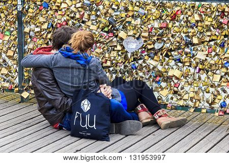 PARIS, FRANCE - MAY 14, 2013: Unknown young couple are looking at a lot of 