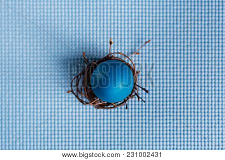 Easter Egg In The Nest On Blue Background