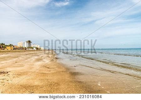 A Landscape Of Sea Coast And Several Hotels