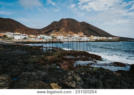 Calhau Village On Ocean Coast In Front Of Red Colored Volcanic Crater. Cape Verde - Sao Vicente Isla