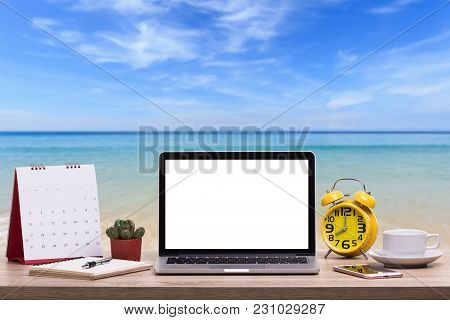 Modern Laptop Computer, Coffee Cup, Alarm Clock, Notebook And Calendar On Wooden Table And View Of T