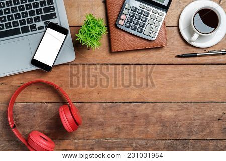 Office Desk Table With Laptop,smart Phone,cup Of Coffee,pen,headphone,calculator And Notebook.top Vi