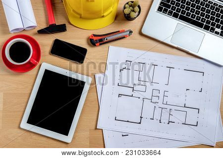 Architectural Office Desk With Laptop,smart Phone,tablet,cup Of Coffee And Engineer Equipment.top Vi