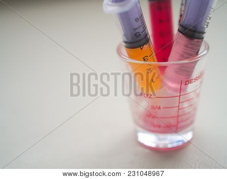 Closeup Liquid Medicine In Syringe In Glass