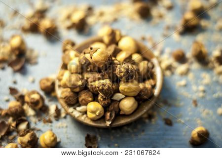 Close Up Of Baked Or Roasted Chickpea/channa Or Dalia In A Bowl On A Blue Surface.