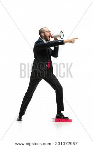 Side View Of Man Screaming On Megaphone Over White Background. Young Casual Man Shouting. Shout. Cry