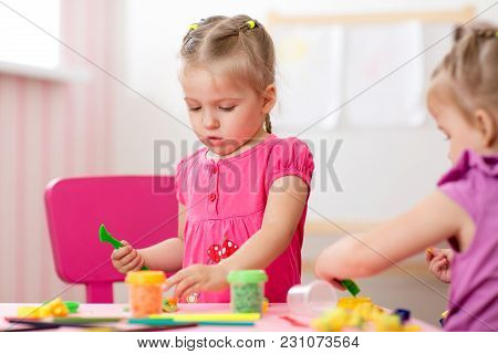 Children Creativity. Kids Sculpts From Play Clay. Cute Little Girl Moulds From Plasticine On Table I