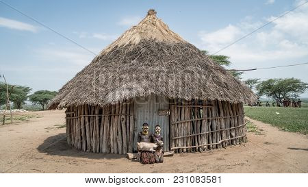Omo Valley, Ethiopia, September 2017: Portrait Of Unidentified Karo Tribe Children Holding A Goat, C