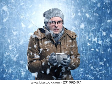 Handsome young boy shivering and trembling at snowstorm concept