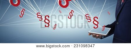 Businessman holding digital tablet against abstract blue background