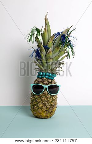 Playful Pineapple Wearing Sunglasses And Palm Cocktail On A Pop Bi-color Background Turquoise And Wh