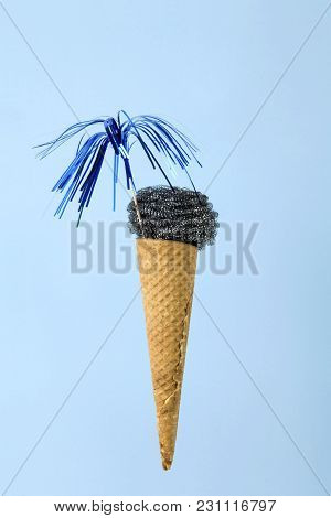 An Ice Cream Cone Whose Scoop Is Replaced By A Metallic Scouring Pad Sponge. Photographic Compositio