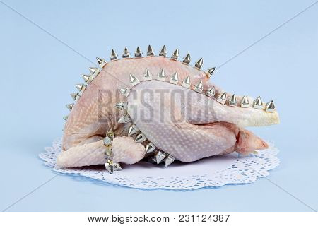 Playful Mashup Using A Chicken And Punk Spikes On A Blue Background. Minimal Color Still Life And Qu