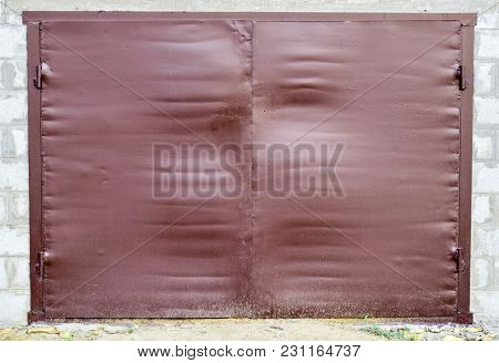 Iron Gates On The Garage. Brown Gates Made Of Steel.