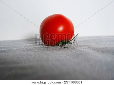 Single Red Tomato And Ripe With Freshly Picked Petiole After Washing