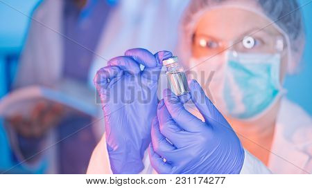 Doctor And Nurse Analyzing Unknown Mmr Vaccine In Medical Clinic Hospital