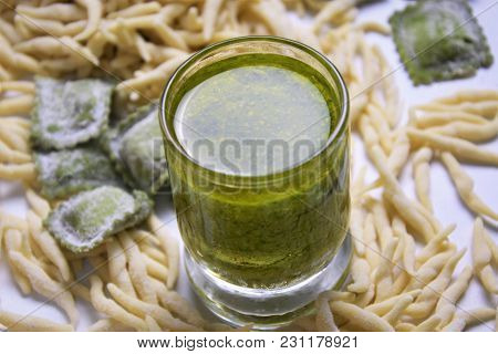Fresh Homemade Uncooked Pasta Italian Trophy And Green Agnolotti And Souce Pesto On A Light Backgrou