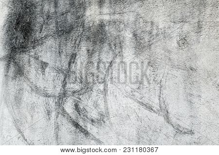 closeup of a rustic off-white plastered wall with some black stains to be used as a background