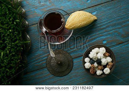 Traditional Azerbaijan Sweet Pastry Shekerbura With Nuts And Honey And Glass Of Black Tea On Wooden 