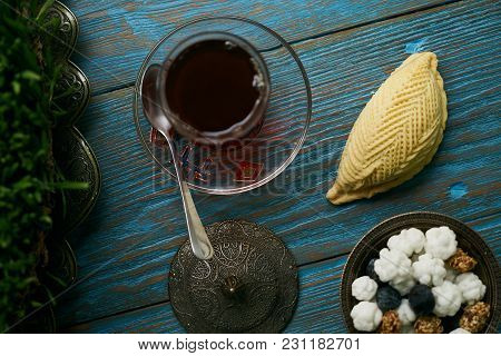 Traditional Azerbaijan Sweet Pastry Shekerbura With Nuts And Honey And Glass Of Black Tea On Wooden 