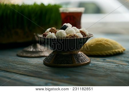 Traditional Azerbaijan Sweet Pastry Shekerbura With Nuts And Honey And Glass Of Black Tea On Wooden 