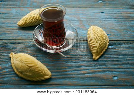 Traditional Azerbaijan Sweet Pastry Shekerbura With Nuts And Honey And Glass Of Black Tea On Wooden 