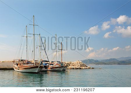 Sailboats On Pier. Calm Sea Water And Blue Sky Background Copy Space