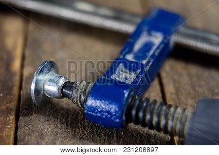 Carpenter's Clamp For Carpentry Work. Accessories In A Carpentry Workshop For Furniture Construction