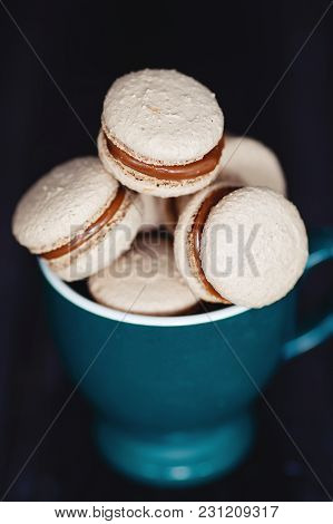 Many Delicious  Makaroons  In A Green Mug. Dark Style