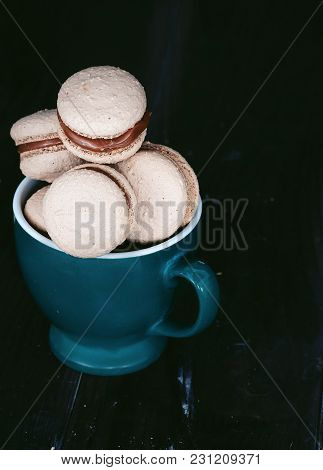 Many Delicious  Makaroons  In A Green Mug. Dark Style