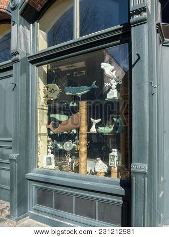 New Bedford, Massachusetts, Usa - March 10, 2018: Whaling Oriented Art Displayed In Window Of Small 
