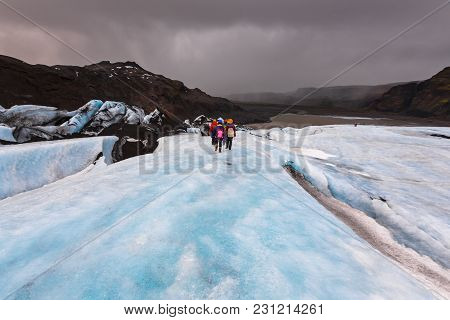 Group Of Hiker Walk On Glacier On Solheimajokull,