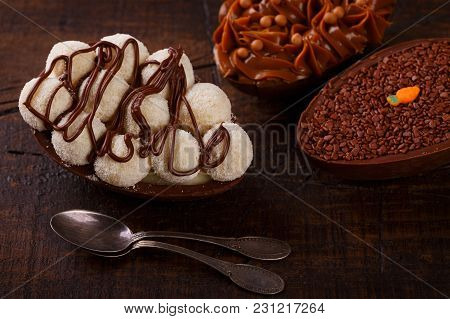 Chocolate Egg Ith Filling For Easter On Wooden Background