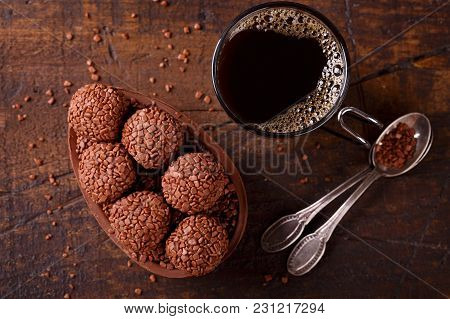 Chocolate Egg With Filling For Easter On Wooden Background