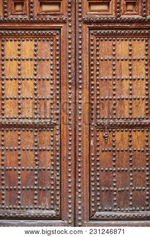 Antique Wooden Door With Iron Inlays. Arquitecture Background. Vertical