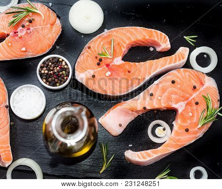 Fresh Raw Unprepared Fish Salmon Or Trout, Steaks, In A Skillet For Cooking, With Salt, Pepper On Bl