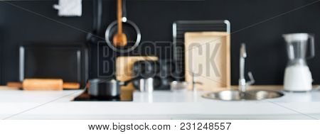 Defocused View Of Cooking Accessories Kitchen Black Wooden Panel Dishes Table Ware Different Support