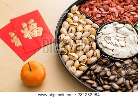 Trdaitional chinese snack tray for Lunar new year with red paket word mean luck