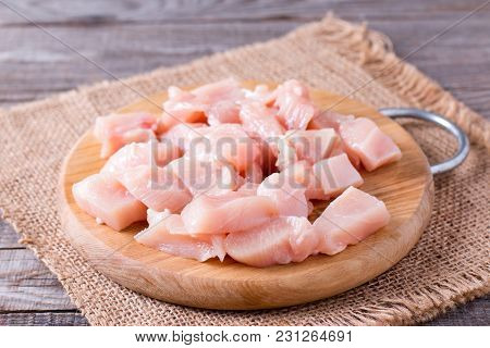 Raw Chicken Meat On Cutting Board On A Wooden Table. Selective Focuson