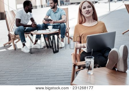 What If. Thoughtful Millennial Girl In Casual Looking Into Vacancy While Sitting With A Laptop On He