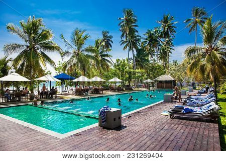 MIRISSA, SRI LANKA-JAN 2, 2017: People into a hotel pool near the Mirissa beach on Jan 2, 2017. Sri Lanka. 