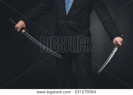 Crppped Shot Of Man In Suit With Dual Katana Swords On Black