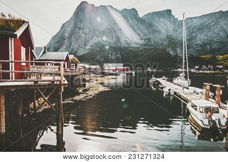 Reine Village In Norway Traditional Rorbu Red Houses At Sea And Rocky Mountains View Travel Scenery 