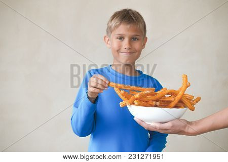 Child Eating Popular Sweat Spanish Dessert Churros.