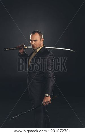 Handsome Man In Suit With Katana Sword Isolated On Black