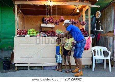 La Romana, Dominican Republic - 02 December 2017: Seller Of Of Fruit And Vegetables Which Arrived In