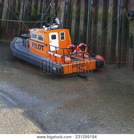 Whitstable, Uk - August 7, 2014: Pluto, A Large Moored Cargo Ship Preparing For The Local Harbour Da