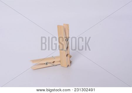 Some Clothespins Making A Chain. It Draws An Abstract 69 Number. Some Wooden Clothespins.