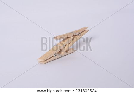 Some Clothespins Making A Chain. It Draws An Abstract 69 Number. Some Wooden Clothespins.